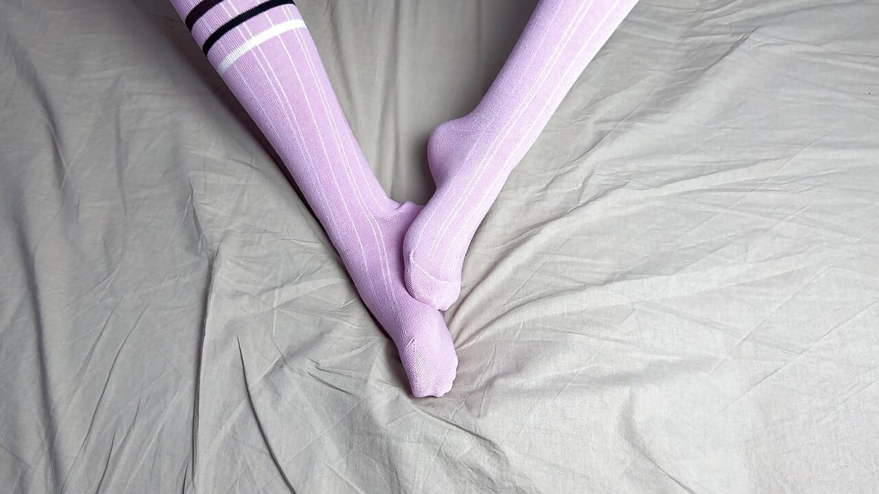 Pink socks in hands of mistress with blue nails in solo video