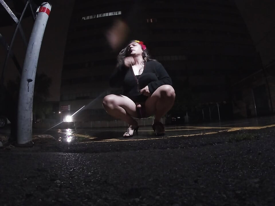 Mature sissy CD out in the rain in A parking lot in public masturbation.