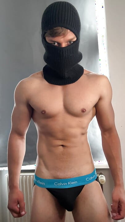 Young bodybuilder posing in a tight jock