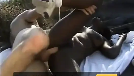 Black and white hairy pussy fucking in dogging position on the beach