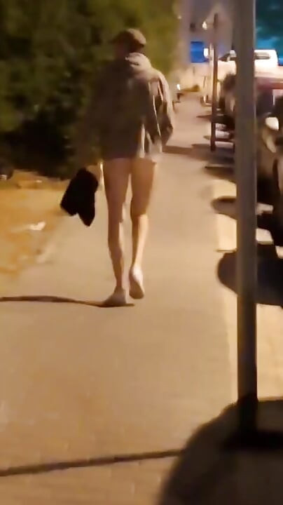 Andando nua pela estrada perto da estação de ônibus