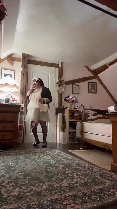 Dressed in a little cream-colored ruffled dress for an evening