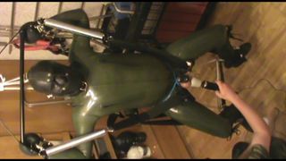 Green and green - swinged rubberslave gets a massage