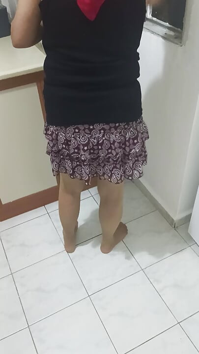 Mature woman in sheer stockings doing housework in the kitchen.