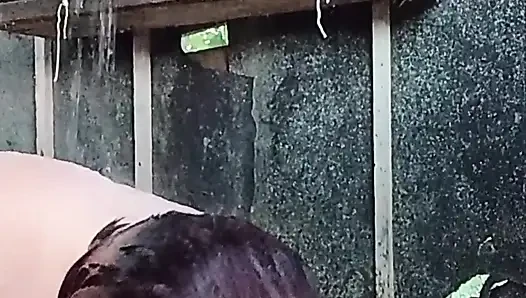 I'm watching a curvy girl wash herself in the street.