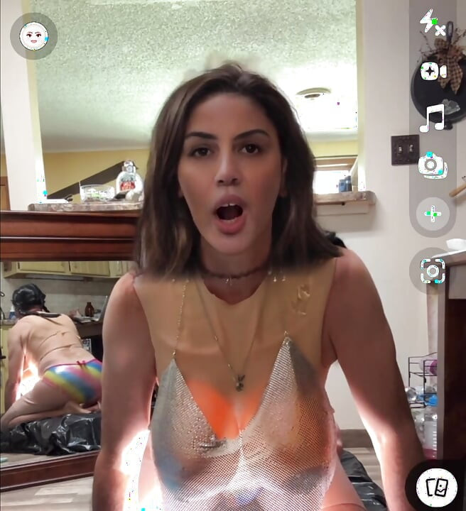 Shemale wearing see-through chainmail top shows off her nice rack