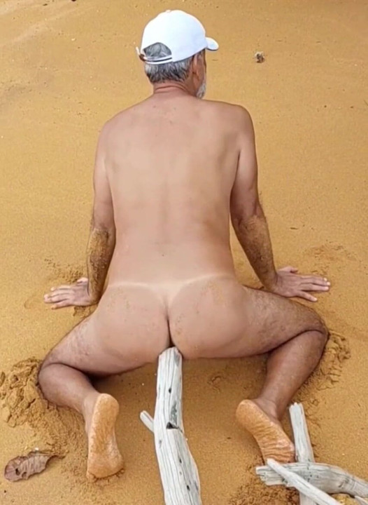 Naked ladysilva on the beach rubbing on big cock