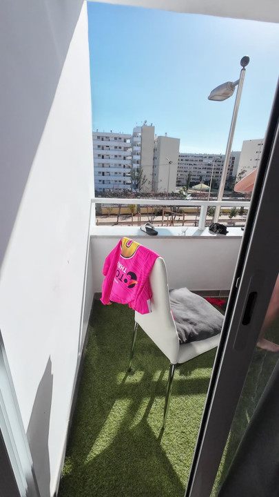 Teasing her while she puts out the clothes to dry in the sunshine