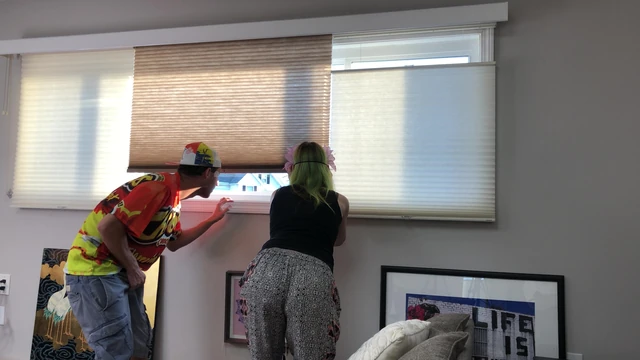 Couple Peeping Outside Apartment Window