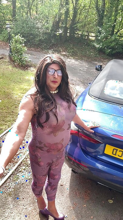 Sexy Crossdresser kellycd2022 in purple catsuit and heels outdoors