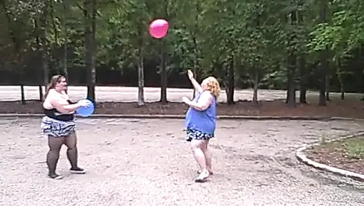 BBW gals play volley ball with balloons