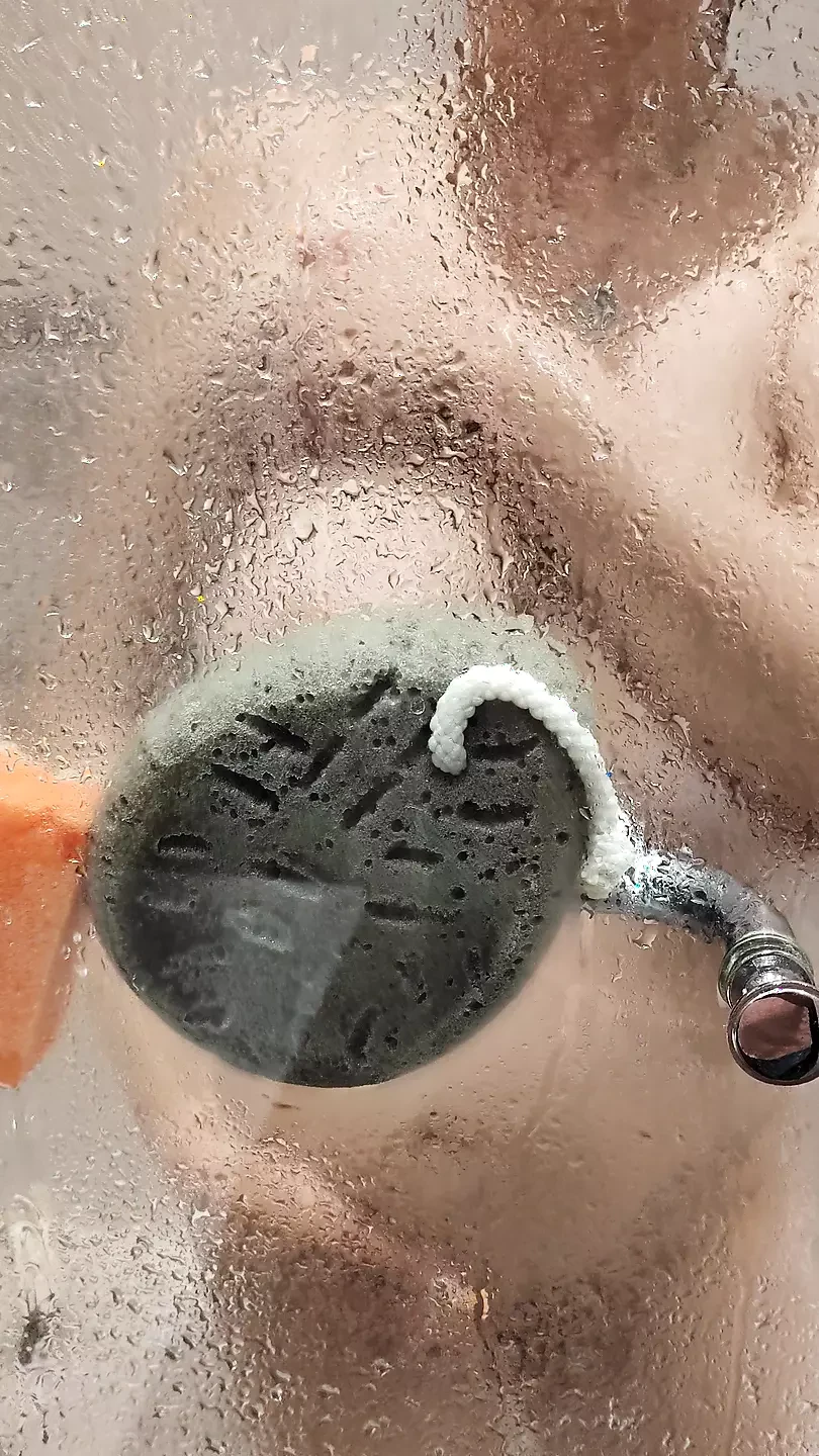 fiery wife's hot shower glow behind foggy glass