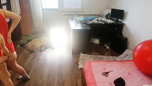 Amateur woman has fun trying on clothes and cutting them.