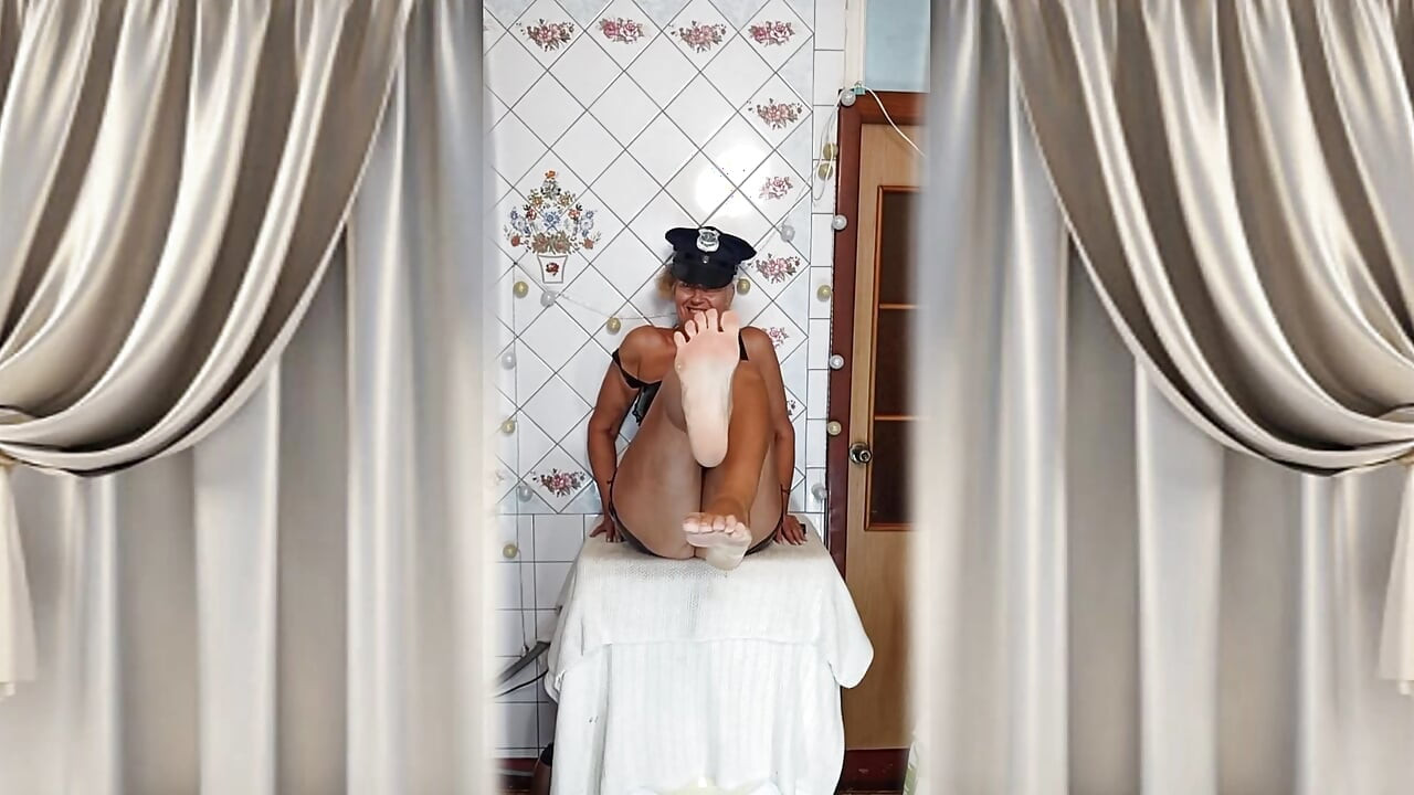 An elderly lady in the kitchen wearing an attractive suit