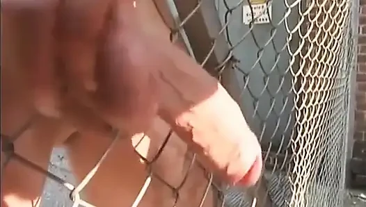 Gimp gets his big dick rubbed outdoor by the mistress