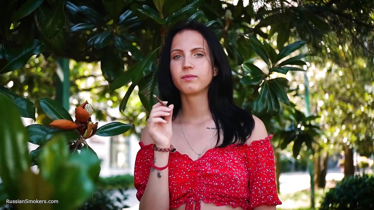 Sultry Brunette in Red Dress Smoking Rolled Cigarette