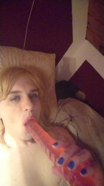 sucking on my dildo in my bed