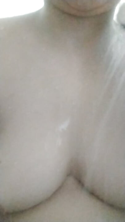 Staife in a shower and play with her breasts