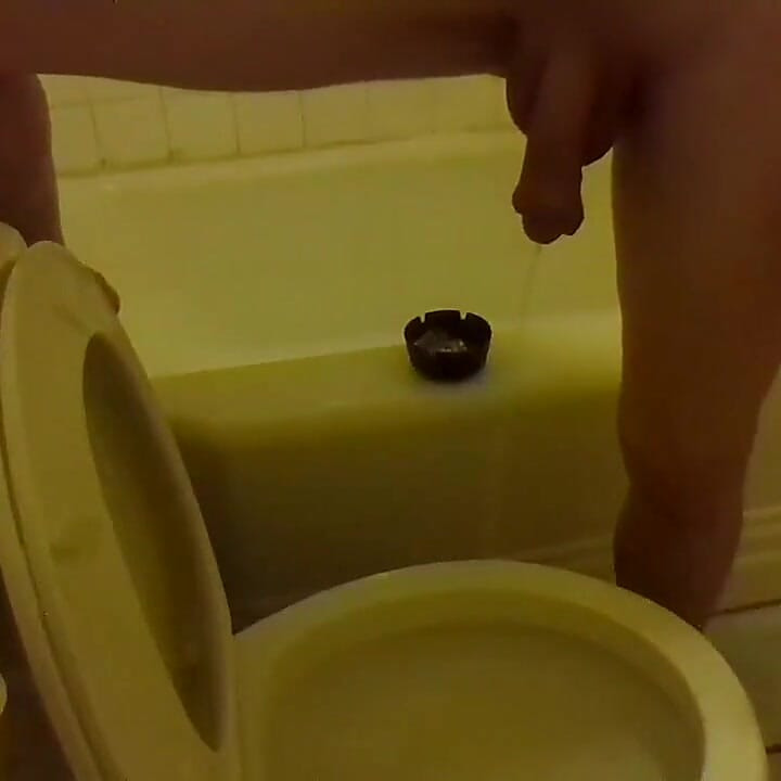 Pissing in the Toilet While Standing on the Bathtub