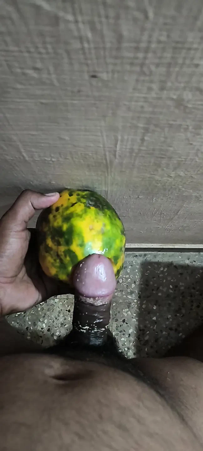 An Indian man enjoys the pleasure of inserting his penis into a papaya fruit