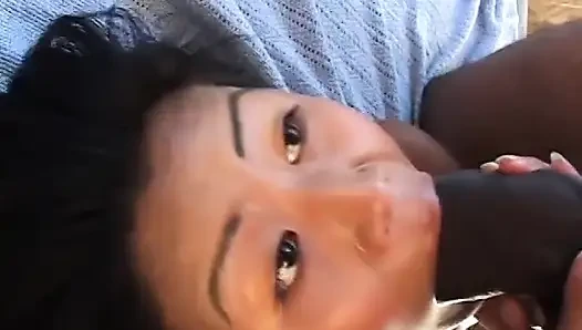 Asian babe with natural tits deep throats a huge black cock before banging