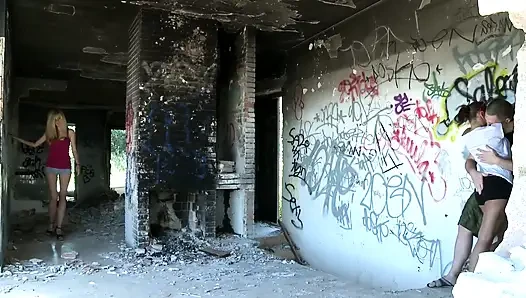 In the squalor of a ruined building, a busty whore gets fucked
