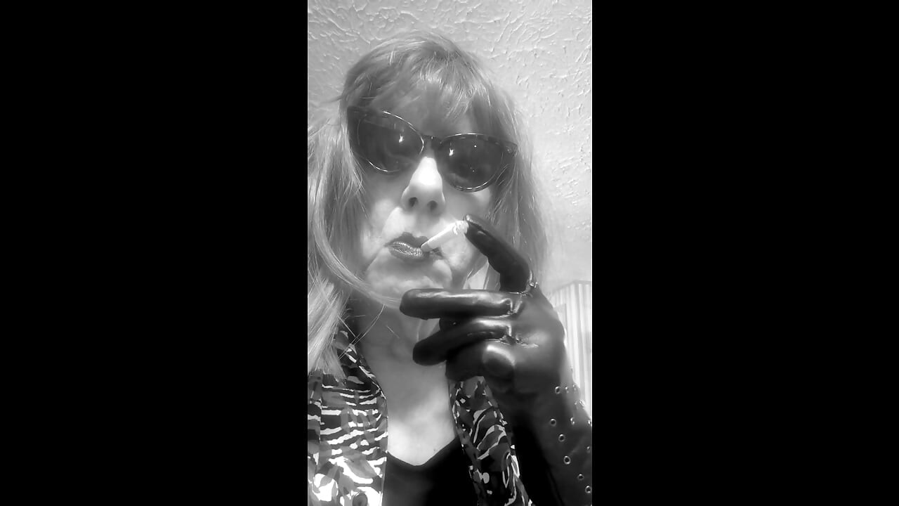 MRS. ROMAN DESTROYING A MARLBORO 100 MENTHOL CLOSE UP - WITH DANGLING AND NOSTRIL EXHALES
