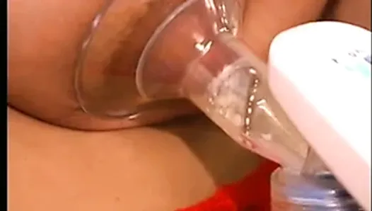 Busty dark nippled brunette uses breast pump to make milk flow from her nips