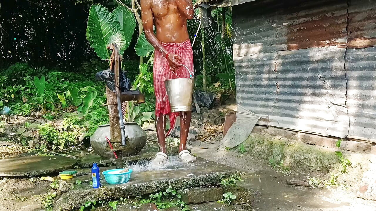 Desi young man bath Open place.