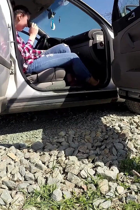 She is almost caught peeing in front of a car
