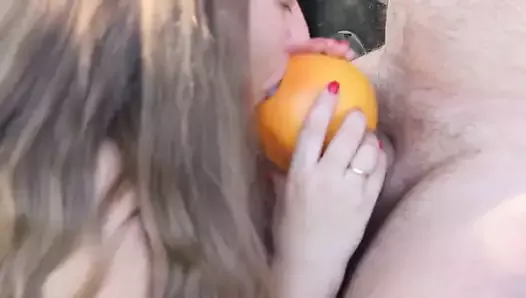 A busty beauty jerks off her boyfriend with a grapefruit