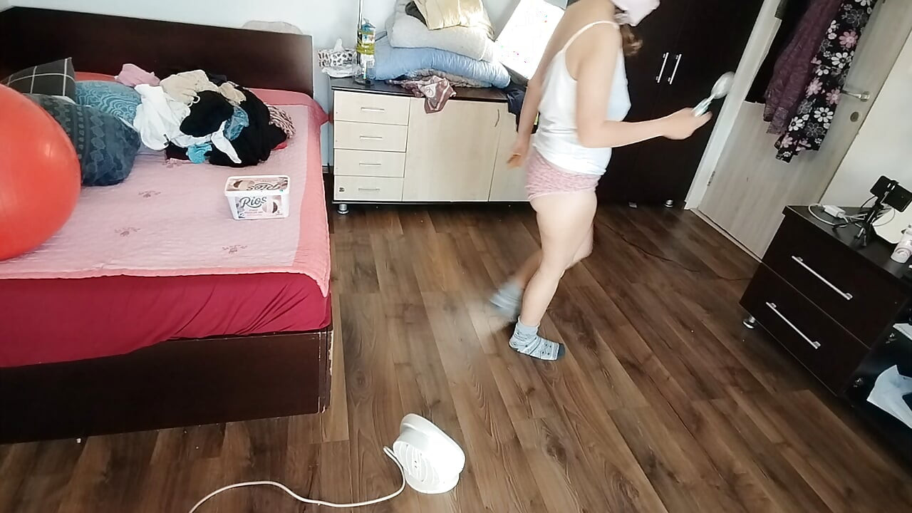 Amateur wife dancing naked at home. Amateur woman has fun trying on clothes and cutting them.