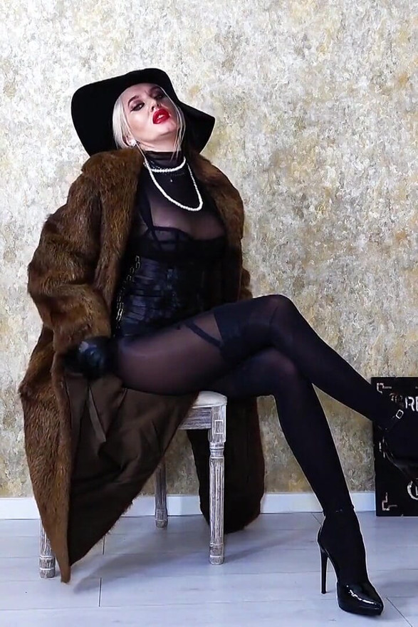 Femme fatale wearing fur coat and leather gloves