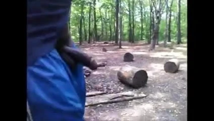 Black guy walks in woods with cock out