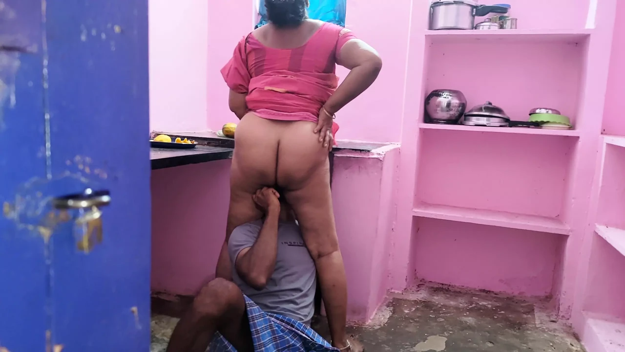 Aunty was searching for a fallen mango in the kitchen and I went behind her and grabbed her rear and licked her pussy wit