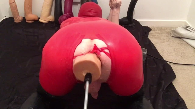 Latex gimp on dildo machine
