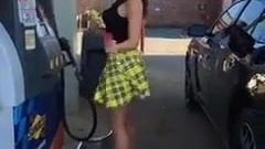 Classy girl pumping gas in yellow mini skirt