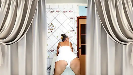 Real home solo of a mature woman in a small cozy kitchen.