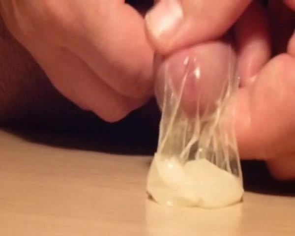 Slow jerking until cum in Condom