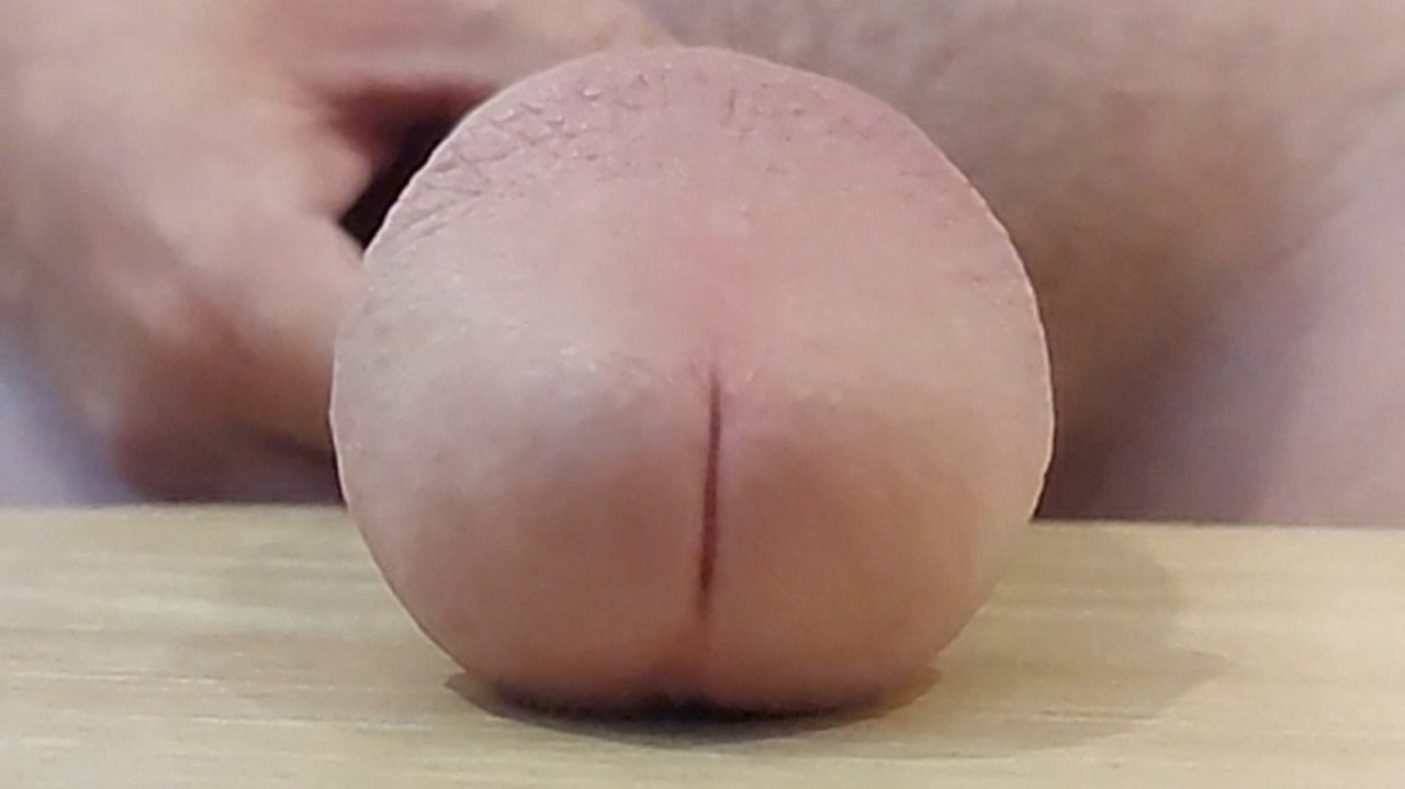 Slapping huge cock on table in slow motion