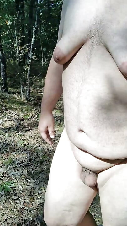 Chubby guy strips, leaves clothes behind and cums in the woods