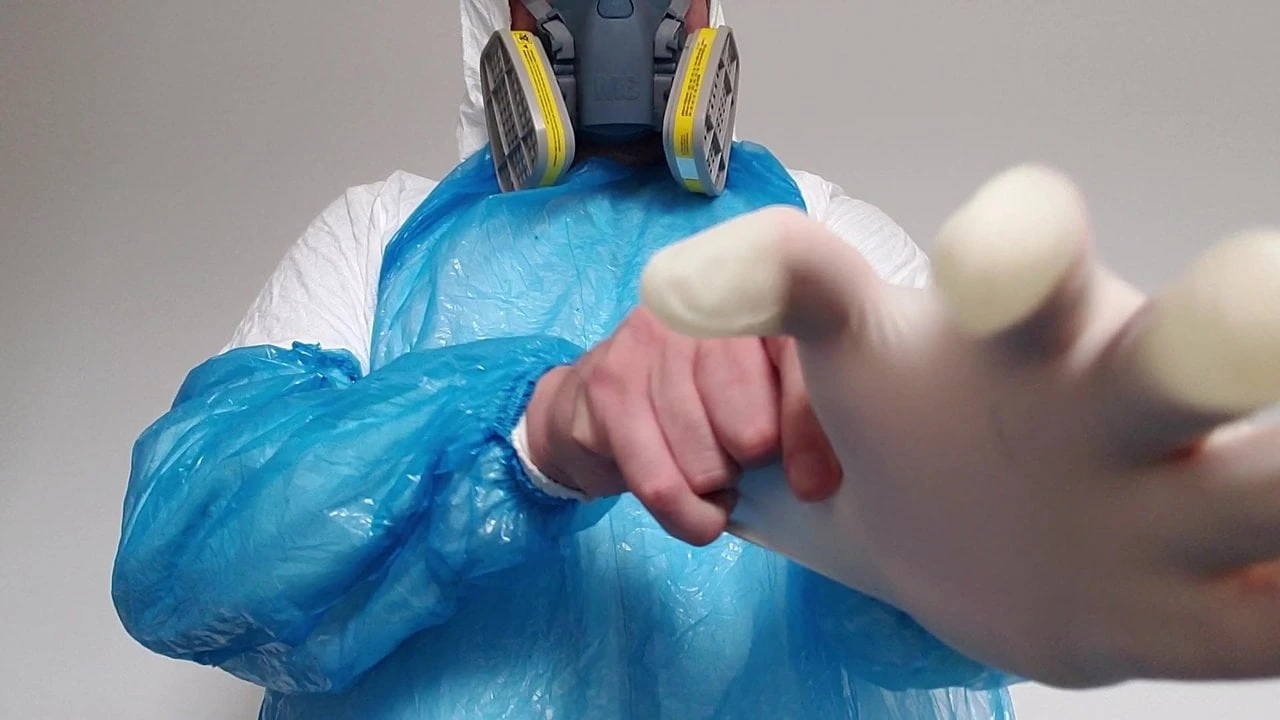 Putting on surgical gloves