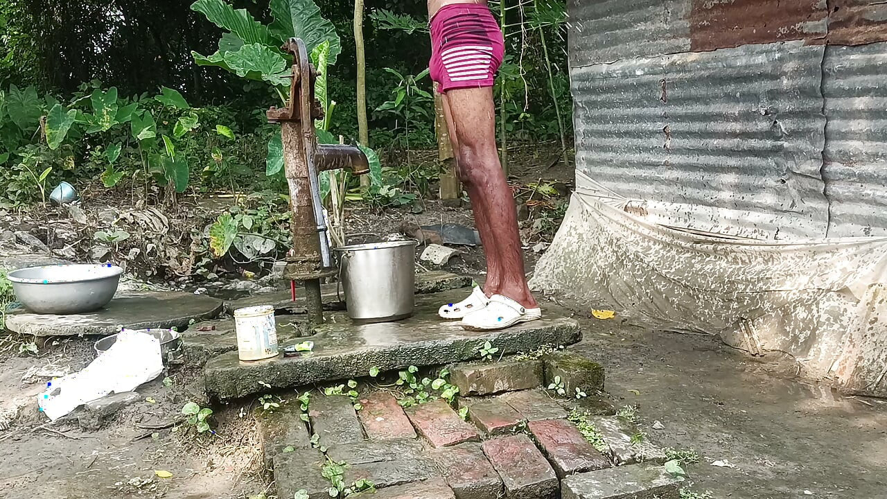 Black mature man bath in desi style. Showing big dick.