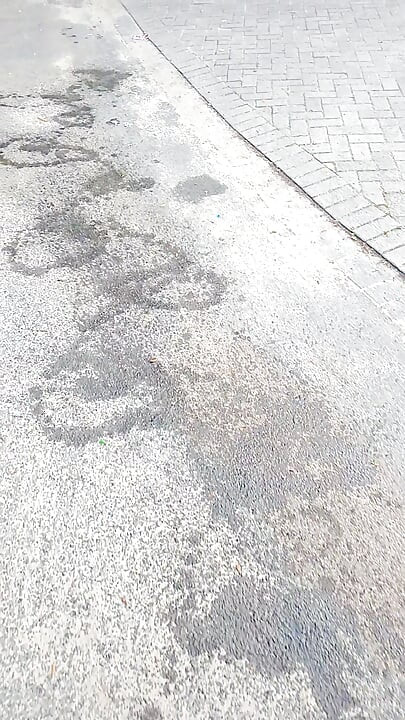 Slender boy pissing on the street. Everyone can watch him