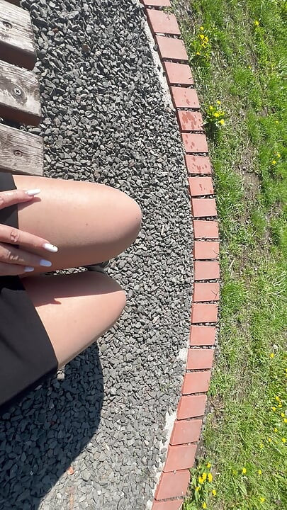 Sexy hot stepmom is horny and caresses herself on a park bench