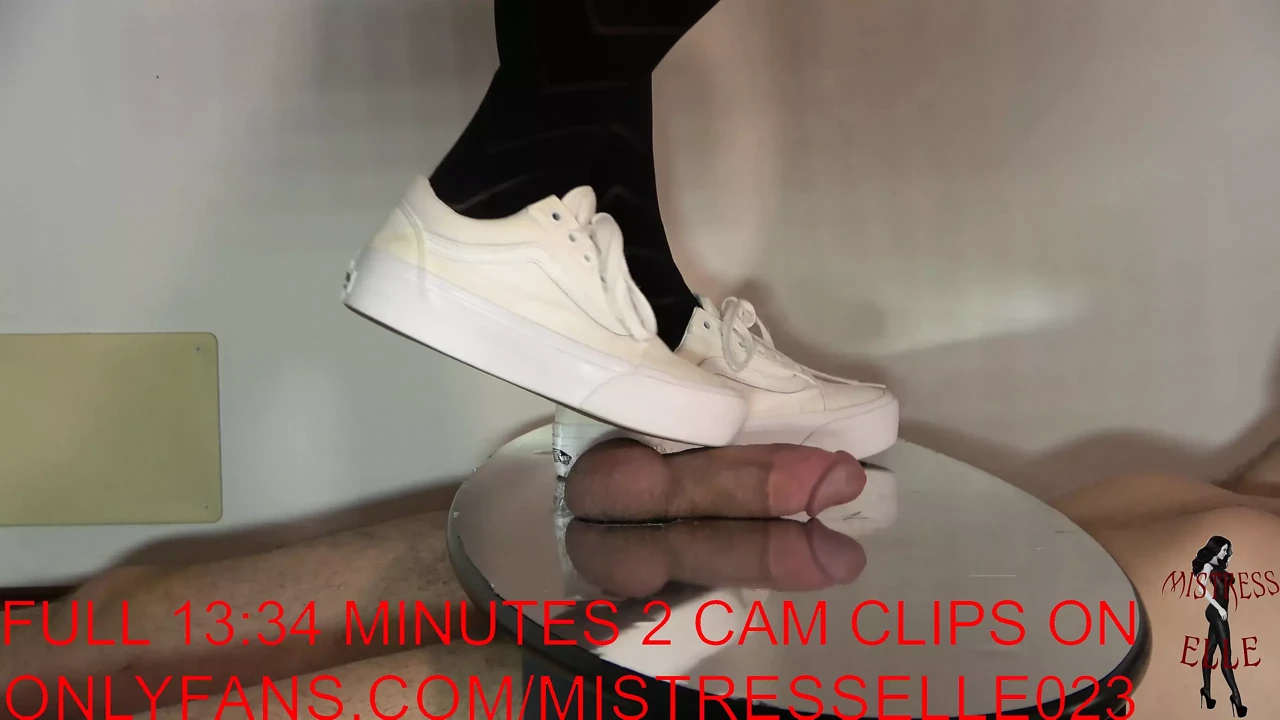 Mistress Elle flattens her slave’s cock with her vans