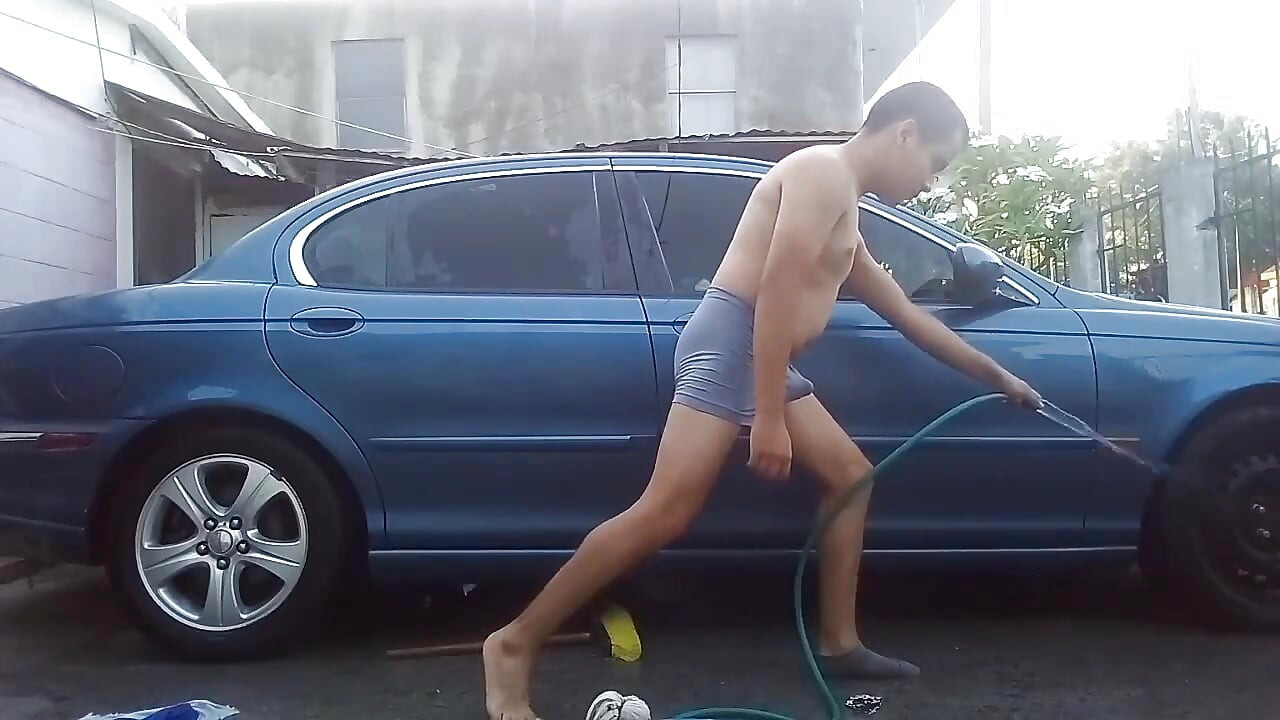 Jesus in gray boxer washing his jaguar car