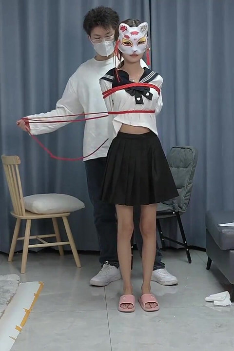 The Barefoot Girl Is Bound with Red Ropes, Tickling Her Feet, and Her Foot Fetishism