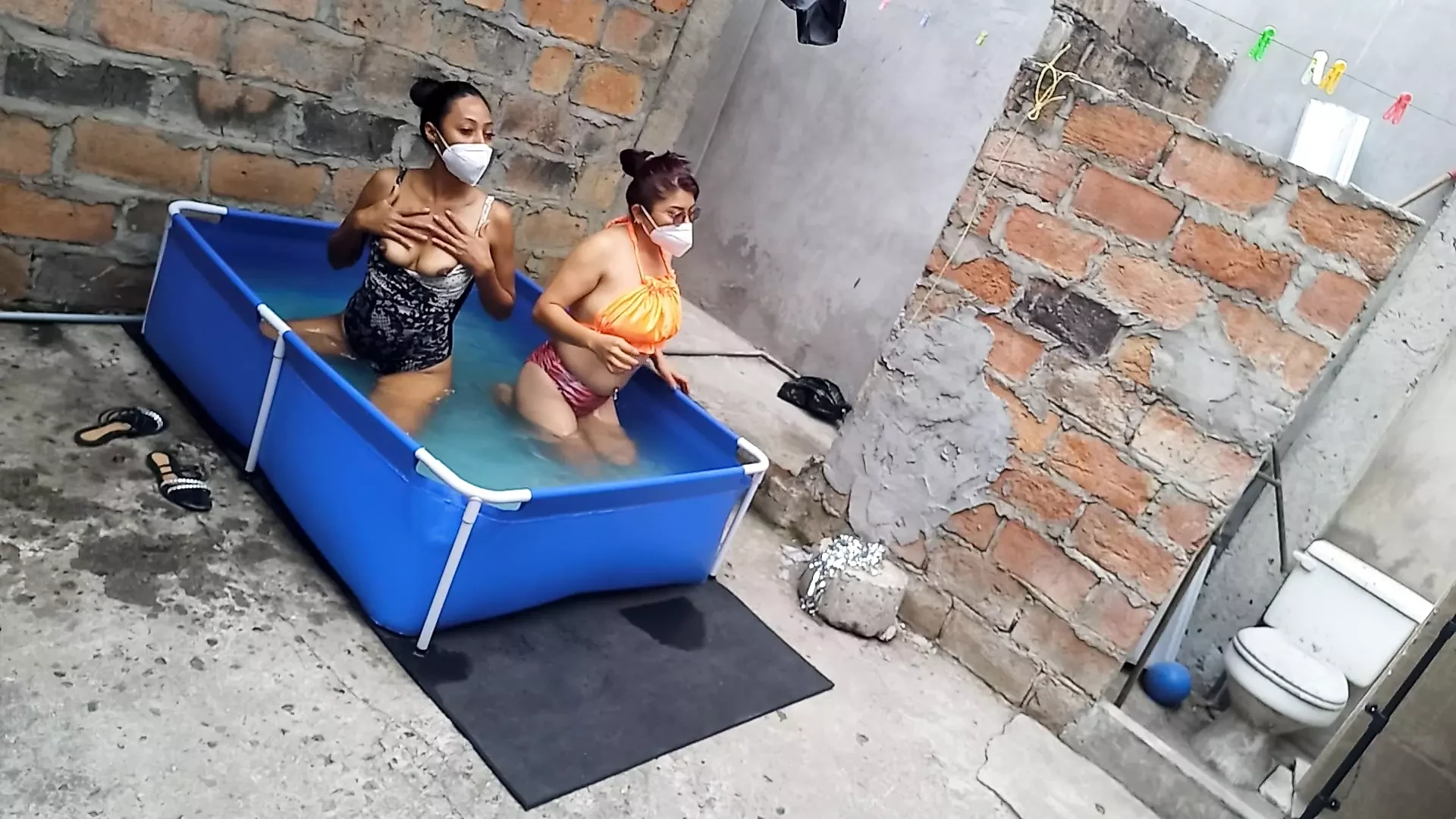 My neighbor is in the pool wearing a very tempting and sexy bikini. She's hot.