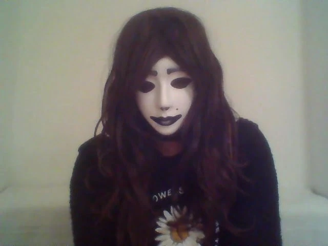 Crossdresser shows off mask on webcam